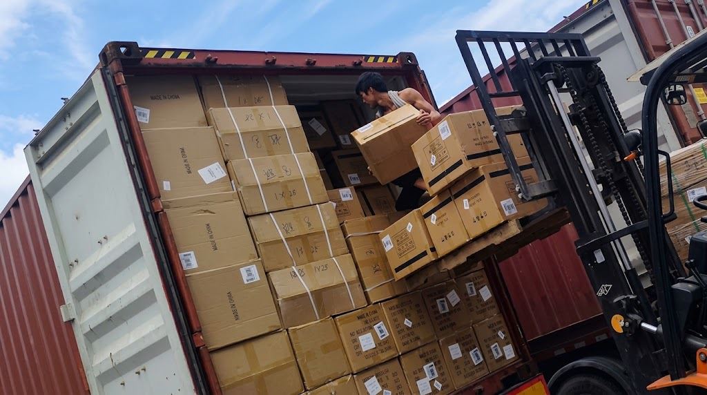 Loading cartons of shoes into a shipping container