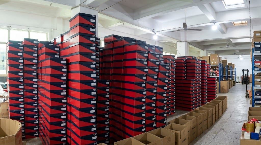 Finished shoes in boxes in the XC Footwear warehouse